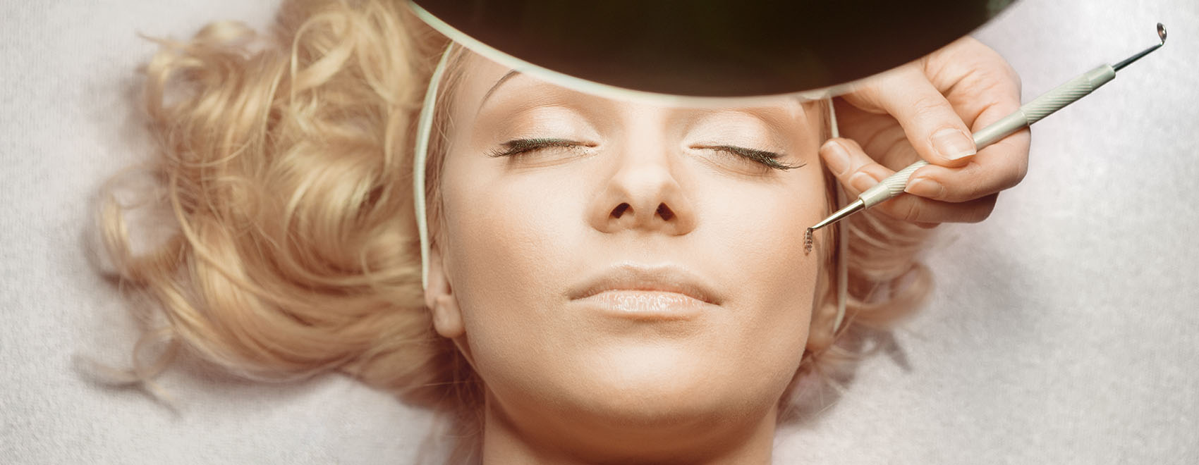 A woman having laser hair removal on her face